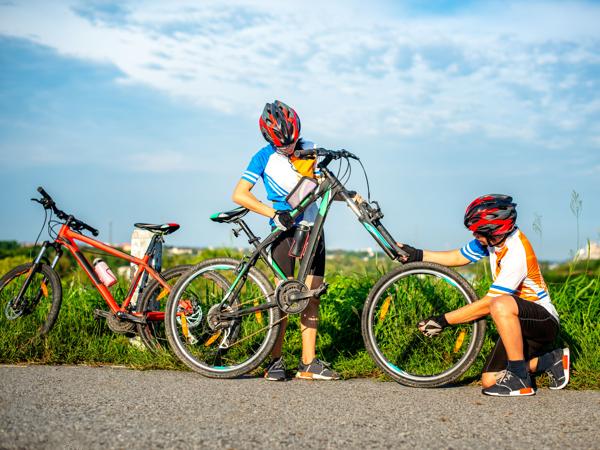 Friends fixing a bicycle tire