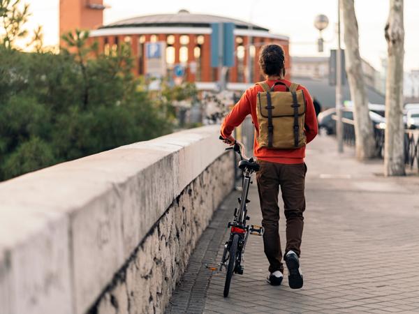 Young man commuting on a folding bicycle