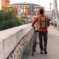 Young man commuting on a folding bicycle